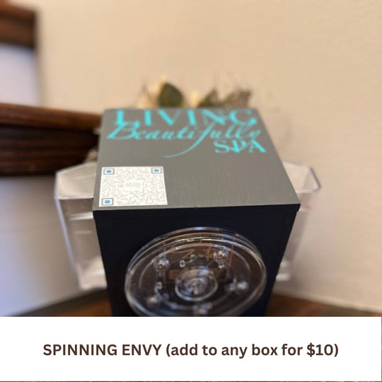 Corporate Envy box shown in black with custom QR code and logo with spinning turntable base for easy scratch-free rotation on surfaces available with monthly or quarterly faux floral subscription refill decor kits