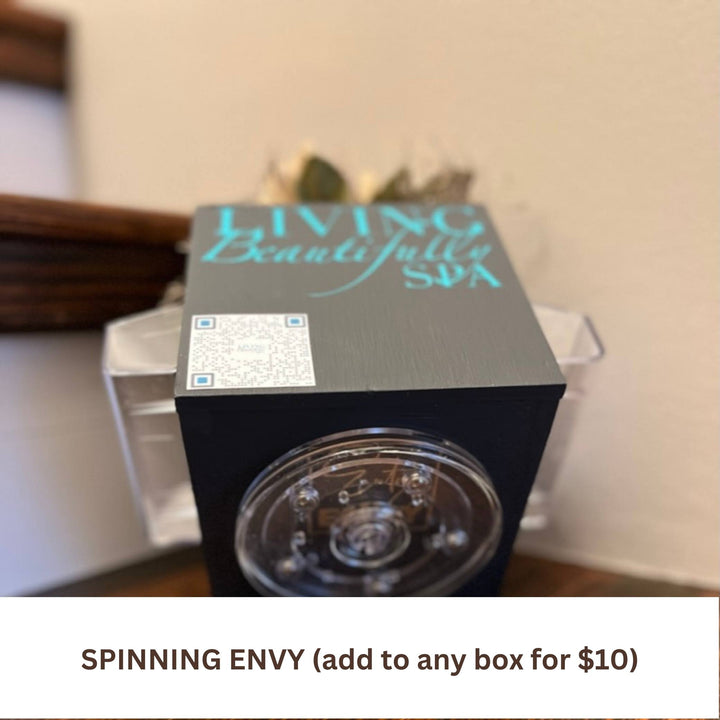 Corporate Envy box shown in black with custom QR code and logo with spinning turntable base for easy scratch-free rotation on surfaces available with monthly or quarterly faux floral subscription refill decor kits