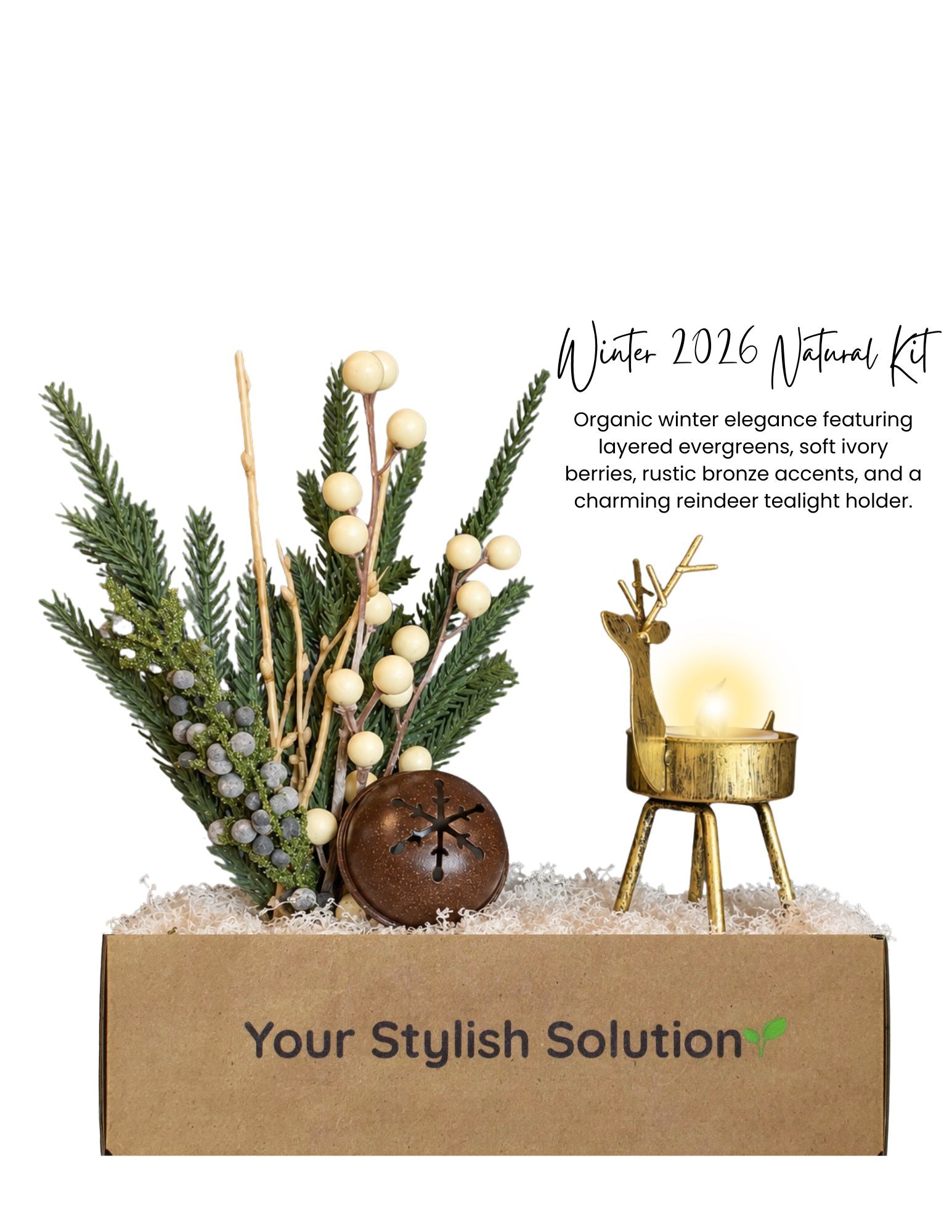 Winter 2026 Natural décor kit featuring evergreen branches, ivory berries, rustic bronze snowflake ornament, and a gold reindeer tealight holder in a branded box.