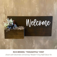 Custom exterior stained brown house sign with hand painted last name in white script with monthly refill decor kit