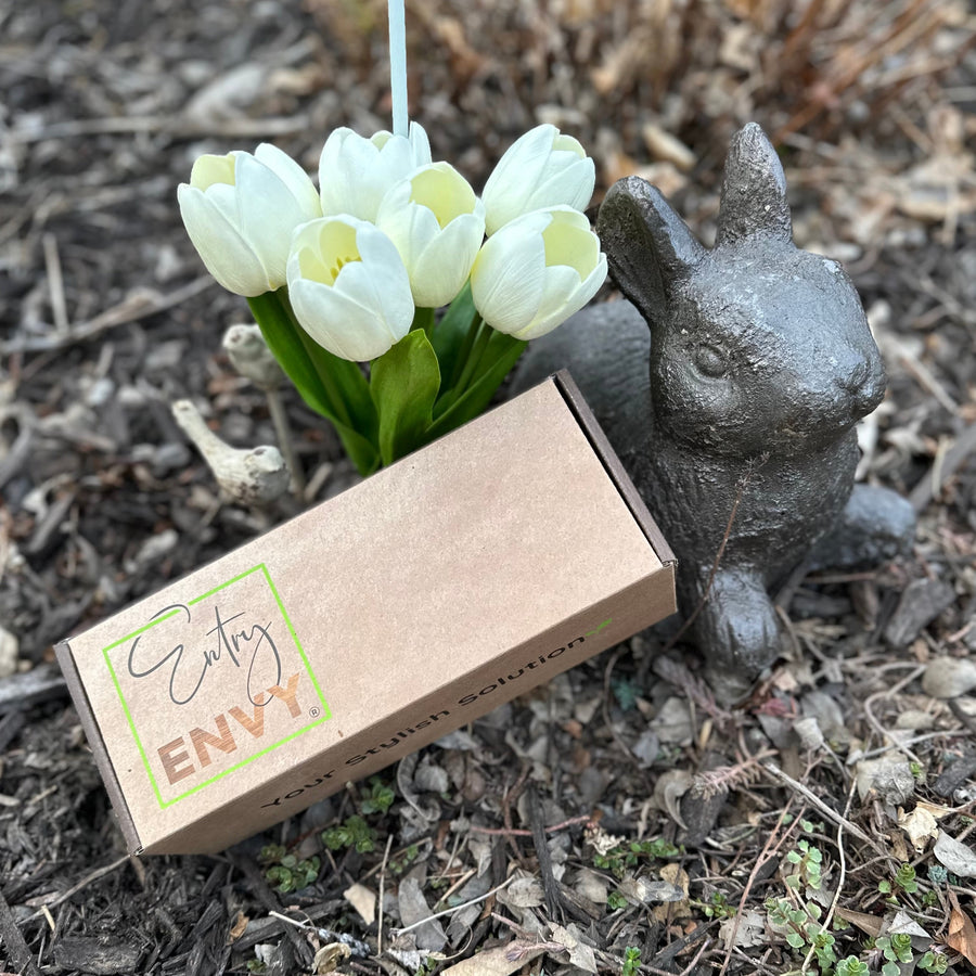Image of box with gift card inside next to white tulips and bunny statue  Edit alt text